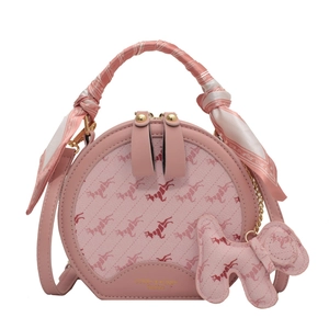 Pink round crossbody bag with horse patterns and decorative silk scarf handle