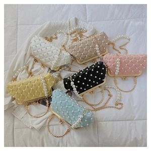 Détail de sacs de soirée matelassés avec perles et poignée anneau dorée