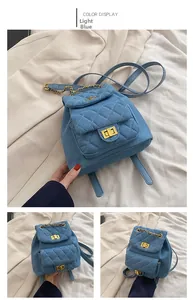 Close-up of light blue quilted denim backpack featuring gold clasp and chain detail