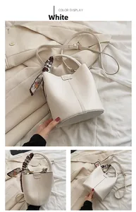 Close-up of white lychee leather bucket bag with decorative geometric print silk scarf