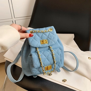 Light blue denim quilted mini backpack with gold chain straps and a classic turn-lock clasp