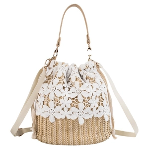 Summer straw bucket bag with floral lace overlay and adjustable beige strap
