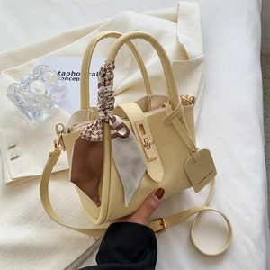 Chic pale yellow lychee textured tote bag with houndstooth scarf and golden lock