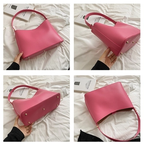 Detail view of large rose pink tote bag with gold metal feet and smooth PU leather finish