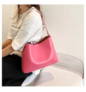 Detailed view of the vibrant rose pink leather shoulder bag with smooth texture and minimal style