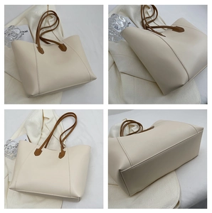 Detailed views of a minimalist cream leather tote bag showing structure and side stitching