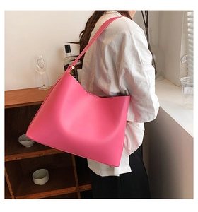 Fuchsia large-capacity faux leather tote bag shown on shoulder for daily commute style