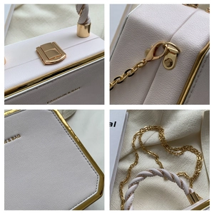 Close-up of golden metal lock and荔枝 texture on elegant pink leather crossbody bag