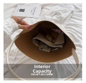 Detail showing internal capacity of off-white lychee leather shoulder bag for daily items