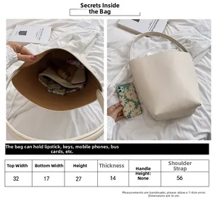 Detailed size guide and interior structure of the white minimalist bucket shoulder bag