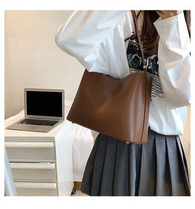 Close-up of a brown leather tote bag with a minimalist design for daily office commuting