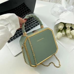 Octagonal sage green leather crossbody bag with gold metal trim and woven handle