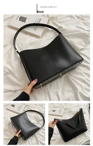 Detail of black matte leather tote bag featuring gold bottom studs and V-shape opening