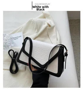 Detail of elegant crocodile pattern texture and black contrast stitching on the shoulder bag