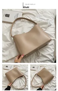 Detail view of khaki faux leather tote bag base with protective gold metal feet