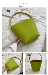 Detailed view of green litchi texture bucket bag with contrast brown interior lining