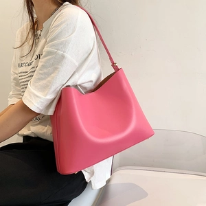 Pink leather tote bag for women with long shoulder straps and gold hardware details