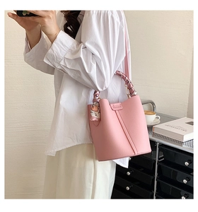 Pink bucket bag in lychee pattern leather with floral silk scarf handle detail
