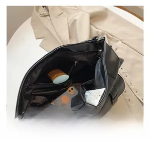 Detail view of the black tote bag interior showing multi-pocket storage and large capacity