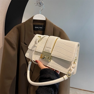 White crocodile pattern crossbody flap bag with a golden square clasp and fashion text