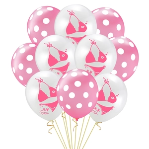 Close-up of flamingo theme latex balloons with polka dots and beach party patterns