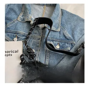 Detail of wide black nylon shoulder strap with textured woven rope on casual oxford bag