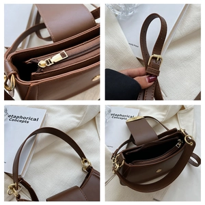 Detailansicht der braunen Ledertasche mit goldenen Beschlägen und verstellbarer Schnalle