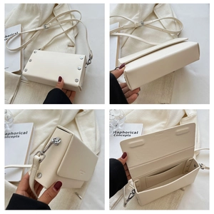 Detail view of cream white minimalist crossbody bag with silver studs and adjustable strap