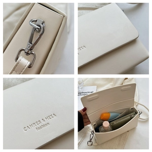 Detail view of cream leather crossbody bag with silver hardware and interior compartments