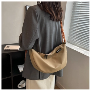 Detailed back view of a khaki crescent nylon crossbody bag with braided rope strap