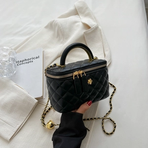 Mini black quilted leather crossbody bag with gold chain strap and floral detail