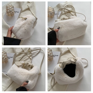 Detail view of plush faux fur handbag with cream PU leather handle and chain strap
