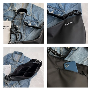 Detailed view of black nylon crossbody bag featuring woven strap and multi-pocket interior