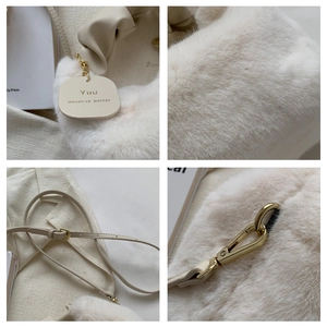 Detail view of white faux fur texture with PU handle and gold metal hardware