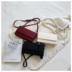 Detailed arrangement of minimalist PU leather crossbody bags in red, beige and black