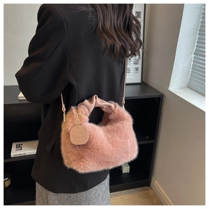 Detail of pink plush faux fur bag with pleated leather handle and slogan hangtag