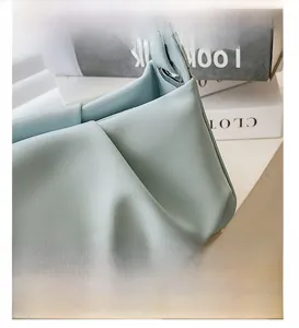 Detail showing natural pleats and corner stitching on the light blue ruched cloud bag