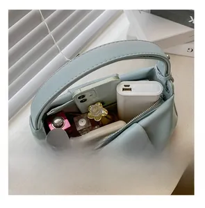 Detail presentation showing the spacious interior of the pleated cloud bag with essentials