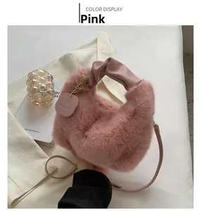 Detail of pink faux fur plush handbag with ruched handle on white blazer and props