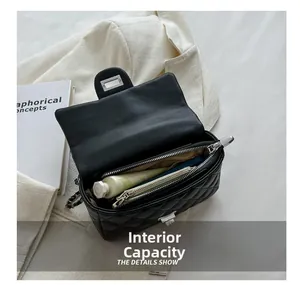 Internal view of black quilted leather crossbody bag showing spacious inner pocket