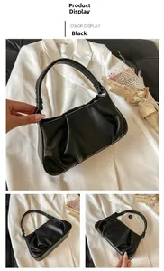 Detail view of the black ruched cloud bag showing matte PU leather and magnetic closure