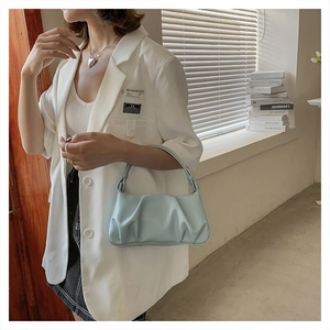 Detailed texture of light blue pleated dumpling bag with soft synthetic leather finish