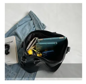 Interior view of black leather tote bag showing large capacity for tablet and umbrella