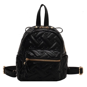 Black mini backpack with heart quilted pattern and gold metal zippers on white background
