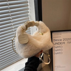 Faux fur handbag with ruched handle and gold chain pendant for autumn winter fashion