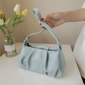 Chic light blue pleated cloud bag with soft leather texture and stylish shoulder strap