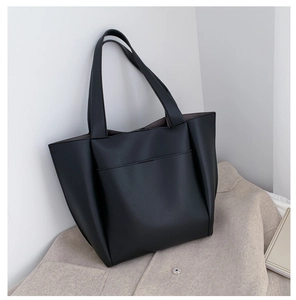 Close-up of black litchi texture PU leather tote bag with front pocket and soft side pleats