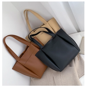 Detail view of large capacity PU leather tote bags in black, brown and beige colors