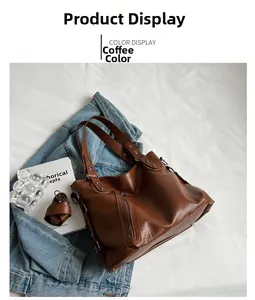 Macro view of coffee brown tote bag showing litchi leather texture and side metal buckle