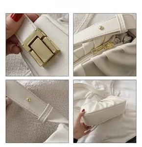 Detailed close-up of cream pleated shoulder bag with gold square buckle and zipper